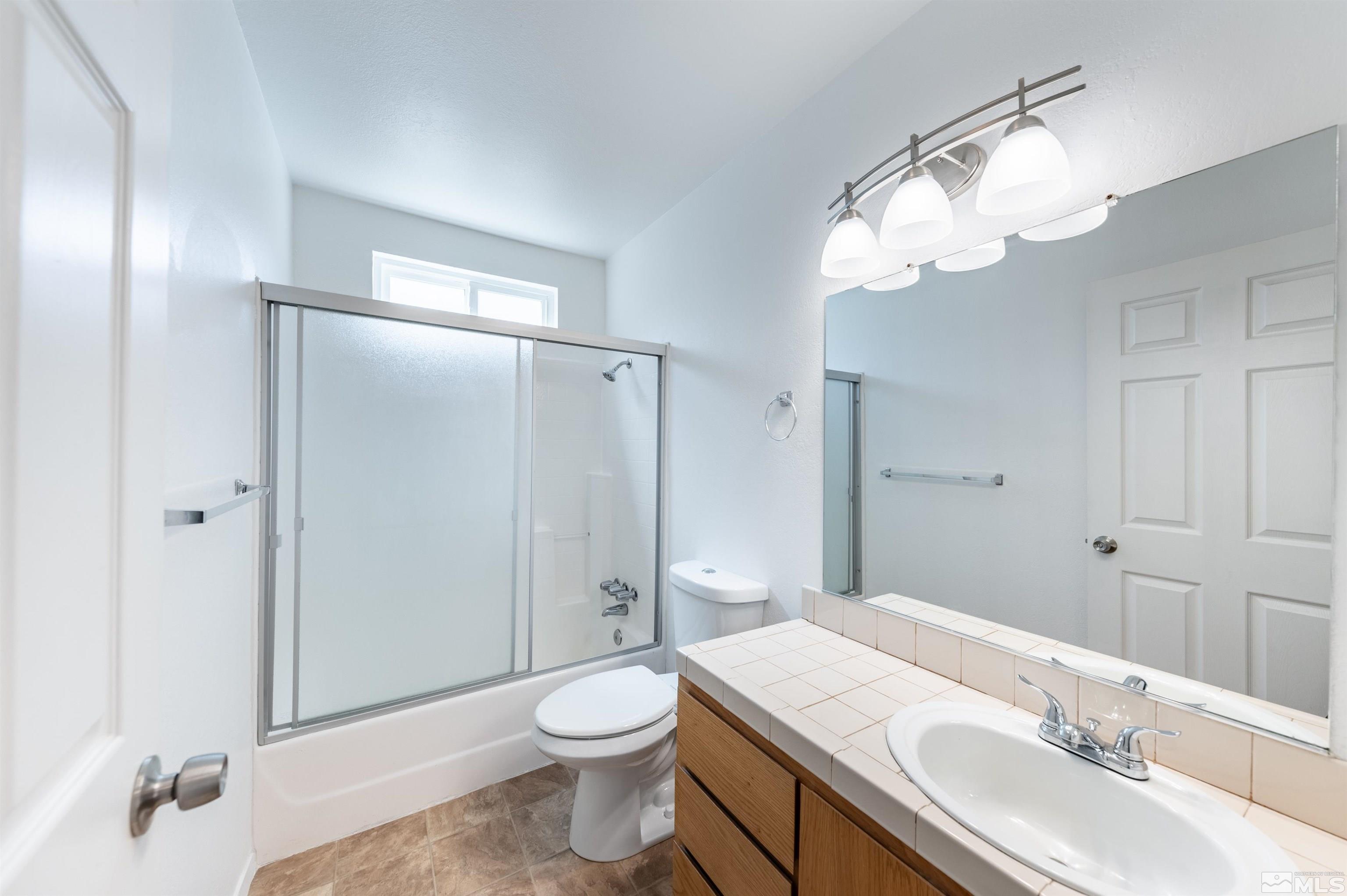 21940 Adobe Road Reno, NV 89521 - Photo 12 of 22 a bathroom with a sink a toilet and shower