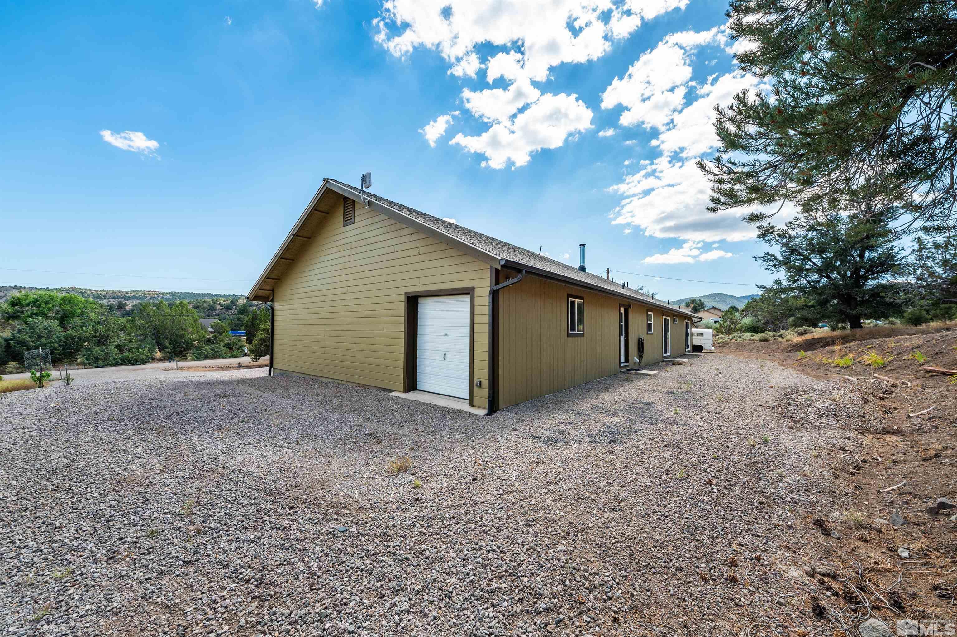 21940 Adobe Road Reno, NV 89521 - Photo 14 of 22 a view of a house with a yard and large tree