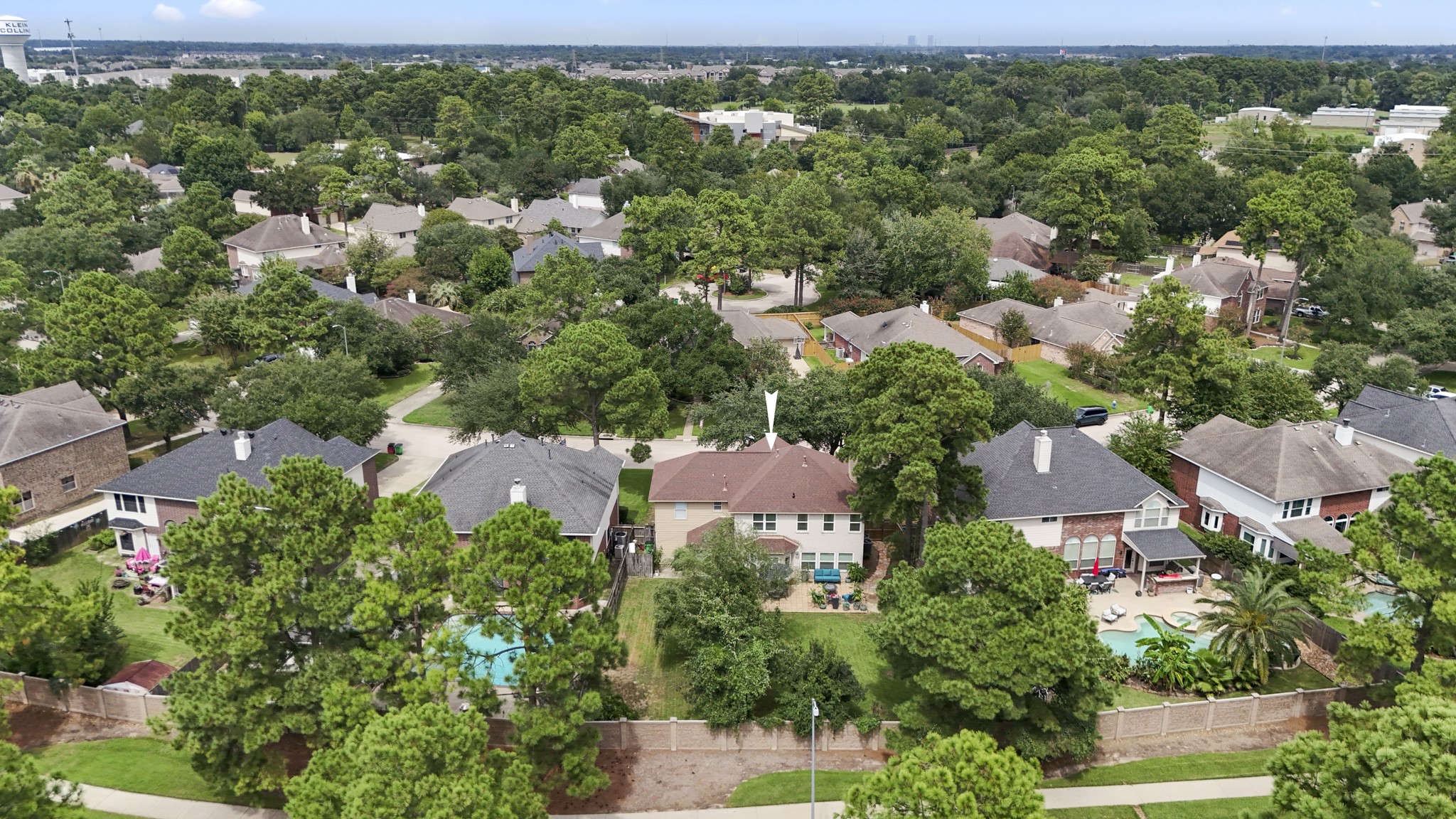 20235 Eden Pines Spring, TX 77379 - Photo 37 of 50 From above, you can really see how the backyard is divided into two distinct outdoor areas. The main yard stays open around the large paver patio for entertaining, play & everyday use, while a separate fenced dog run stretches along the right side of the property from the house toward the back fence. Mature trees help define the spaces, and no home sits directly behind, giving the backyard an even more open feel.