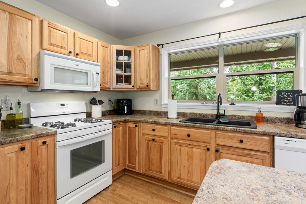 204 Hiawassee River Road Murphy, NC 28906 - Photo 19 of 79 a kitchen with granite countertop a stove sink and cabinets