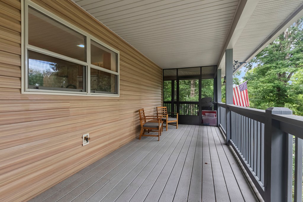 204 Hiawassee River Road Murphy, NC 28906 - Photo 32 of 79 a view of a balcony with chairs and wooden floor