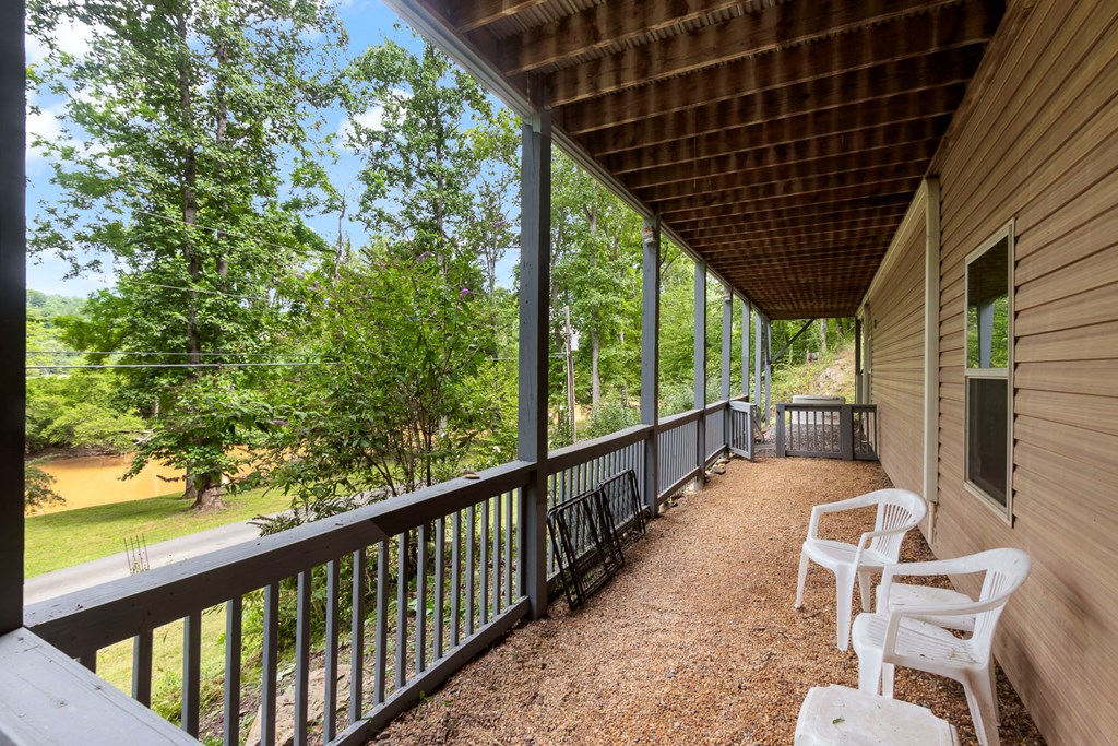 204 Hiawassee River Road Murphy, NC 28906 - Photo 65 of 79 a view of a porch with wooden floor in front of a house