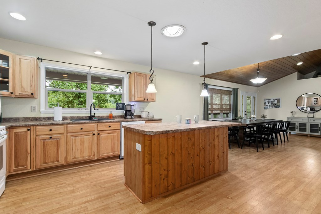 204 Hiawassee River Road Murphy, NC 28906 - Photo 8 of 79 a kitchen with stainless steel appliances granite countertop wooden cabinets a stove a sink and a large window