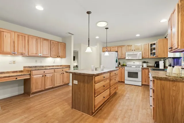 a bathroom with a granite countertop sink a mirror and a toilet