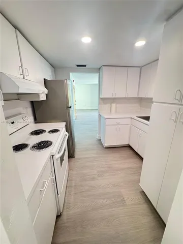 a white refrigerator freezer sitting inside of a kitchen