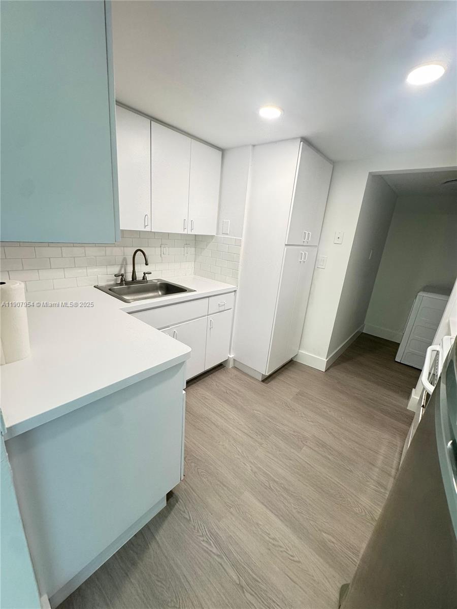 11780 Southwest 18th Street, Unit 5282 Miami, FL 33175 - Photo 14 of 19 a kitchen with a sink a stove a refrigerator and cabinets