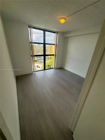 an empty room with windows and closet