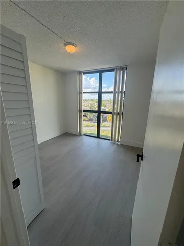 an empty room with an entrance and closet