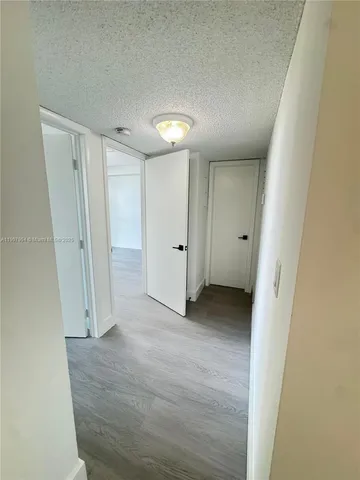 a kitchen with a stove sink and cabinets