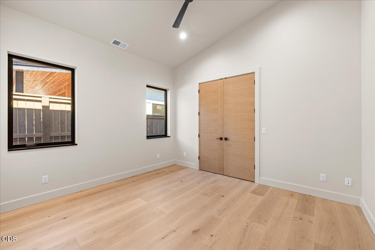 391 Clinton Street Ashland, OR 97520 - Photo 31 of 41 a view of an empty room with window and wooden floor