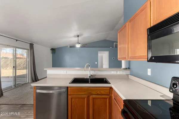 a view of a kitchen with a sink and a refrigerator