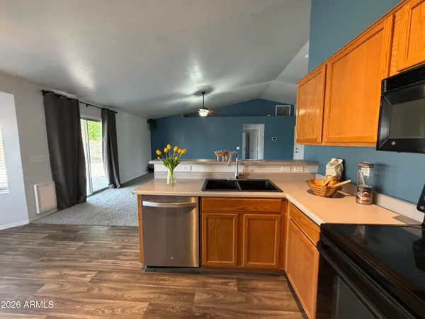 a kitchen with stainless steel appliances granite countertop a refrigerator a stove and a sink