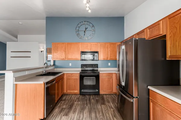 a kitchen with stainless steel appliances a stove a sink and a microwave