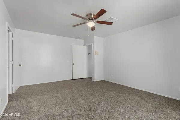 a bedroom with a large bed and a flat screen tv