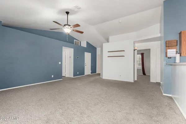 a view of an empty room with a ceiling fan