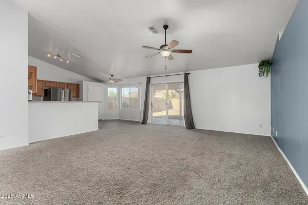 a view of a livingroom with a ceiling fan and window