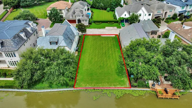 an aerial view of a house with a garden and swimming pool