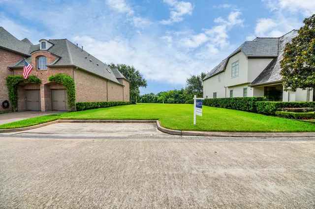 an aerial view of residential houses with outdoor space and swimming pool