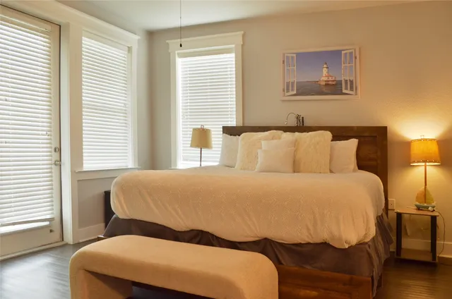 a living room with furniture a large window and a flat screen tv