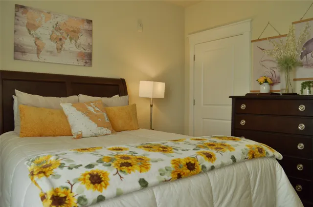 a bathroom with a granite countertop double vanity sink mirror and shower