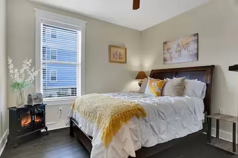 a bedroom with a bed and painting on the wall