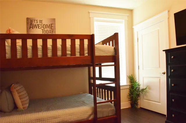 a bedroom with a bed and a painting on the wall