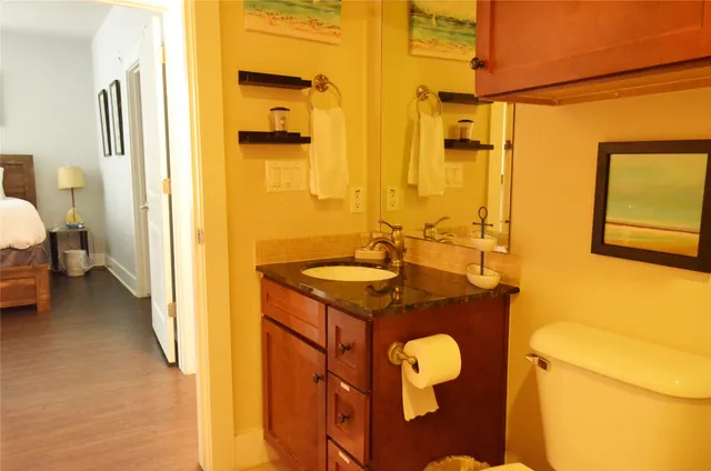 a bathroom with a granite countertop sink toilet and shower