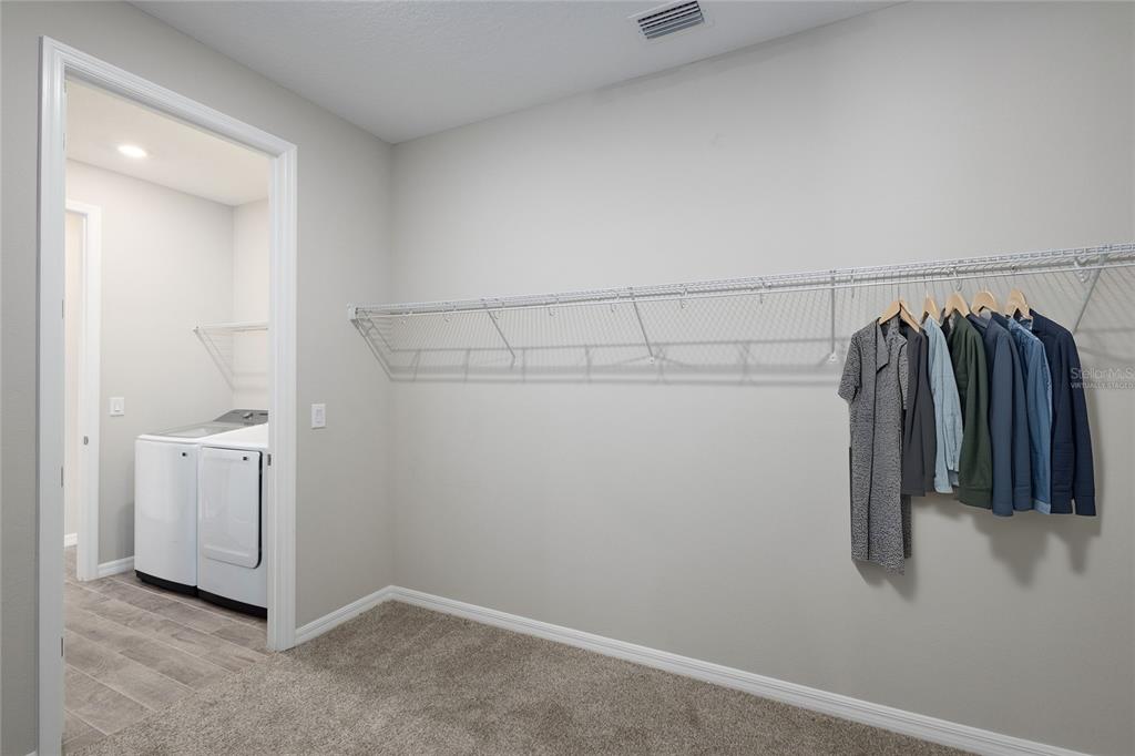 5604 Blue Reef Place Nokomis, FL 34275 - Photo 18 of 45 a view of walk in closet with clothes and shoes