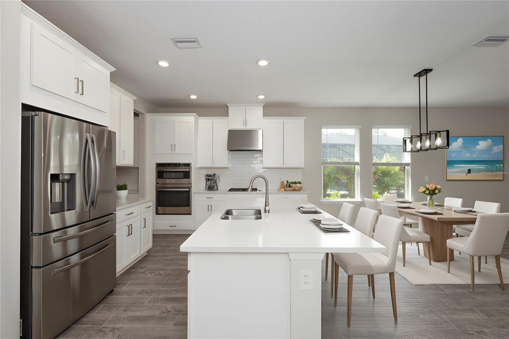 5604 Blue Reef Place Nokomis, FL 34275 - Photo 20 of 45 a kitchen with a sink stainless steel appliances and cabinets