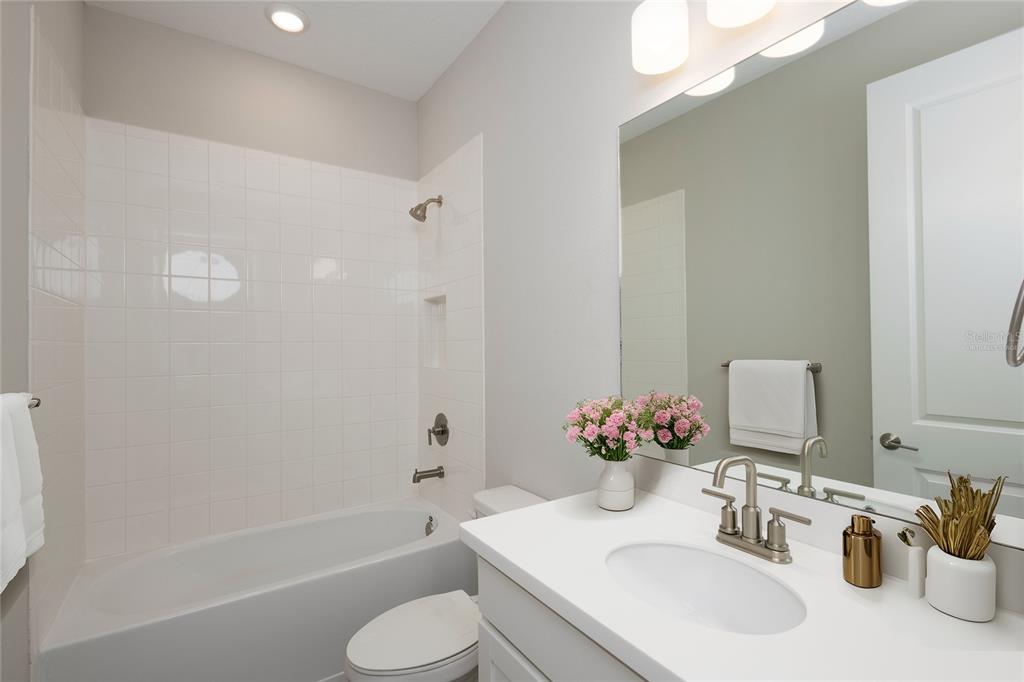 5604 Blue Reef Place Nokomis, FL 34275 - Photo 27 of 45 a bathroom with a sink toilet and shower