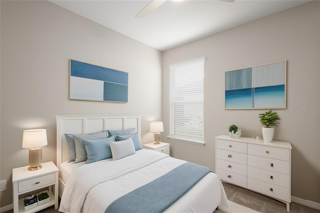 5604 Blue Reef Place Nokomis, FL 34275 - Photo 29 of 45 a bedroom with a bed and a lamp on dresser