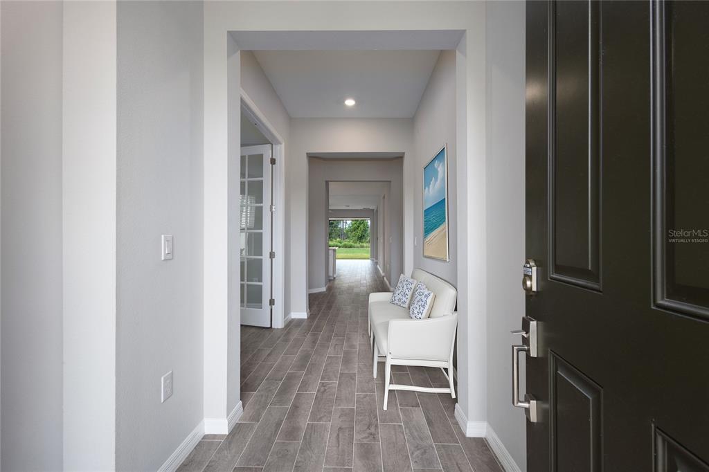 5604 Blue Reef Place Nokomis, FL 34275 - Photo 3 of 45 a view of a hallway view with wooden floor and staircase