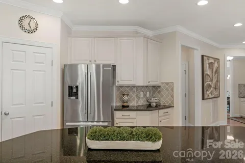 a dining room with wooden floor and a potted plant