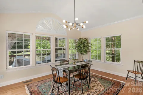 a living room with furniture a fireplace and a chandelier