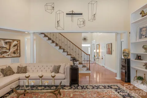 a living room with furniture and large windows