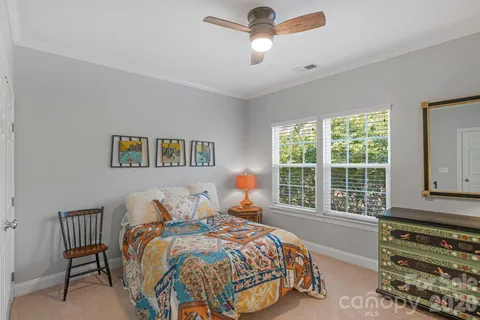 a bedroom with a bed and a lamp