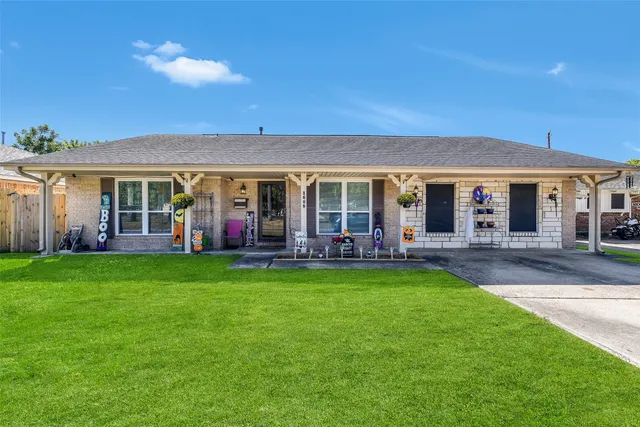 a view of a house with a yard patio and swimming pool