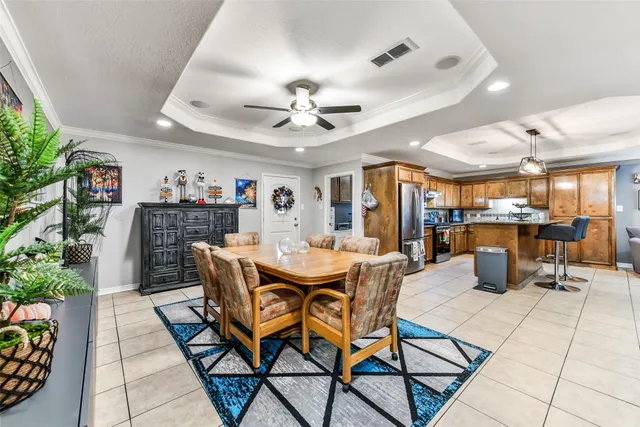 a view of a dining room with furniture and a kitchen