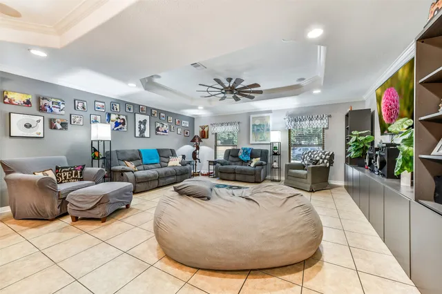 a living room with furniture kitchen and a chandelier