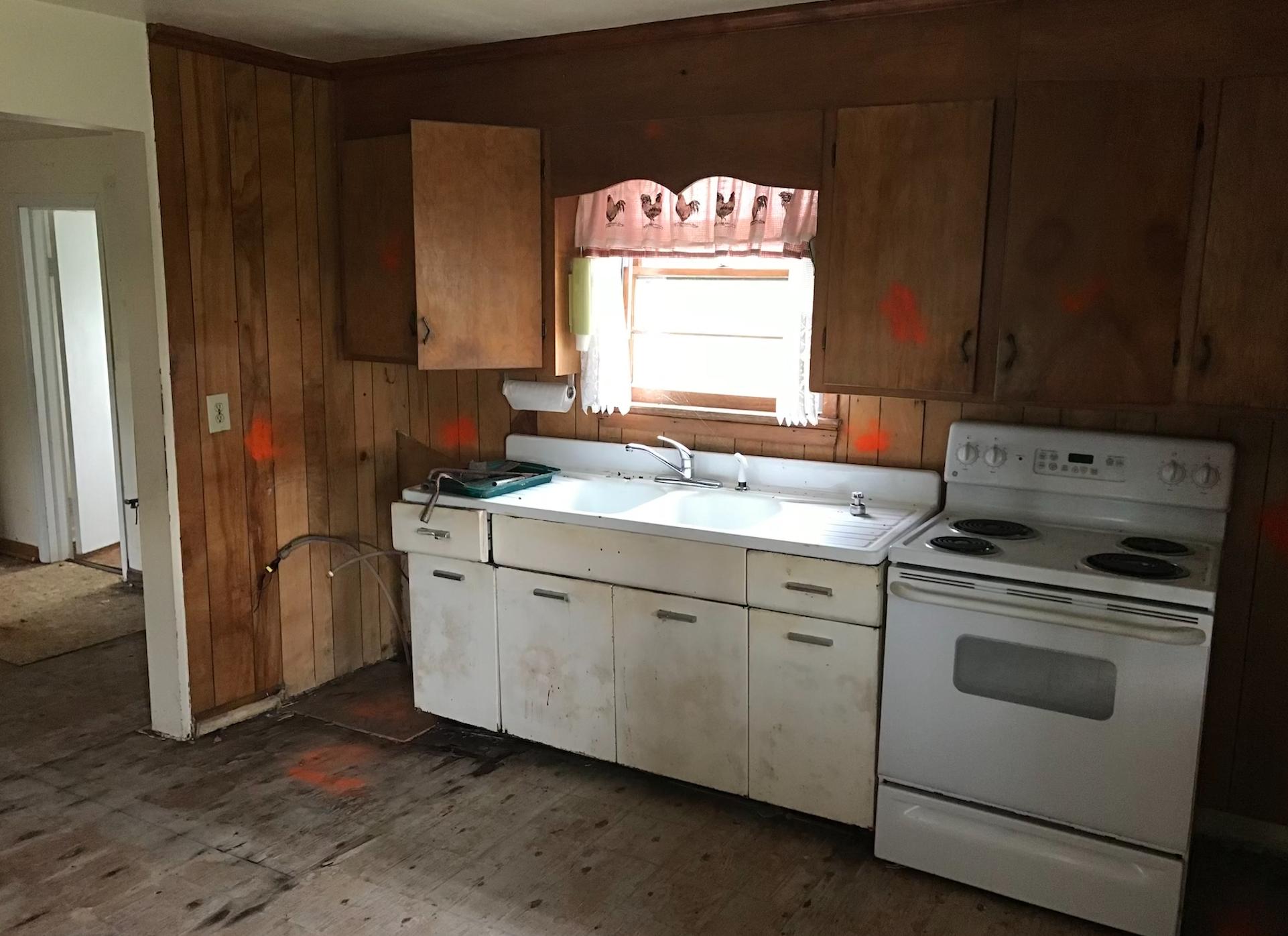 1145 Horse Ridge Road Northwest Willis, VA 24380 - Photo 23 of 29 a kitchen with a stove sink and cabinets