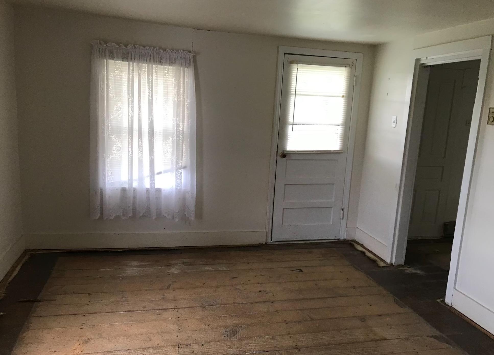 1145 Horse Ridge Road Northwest Willis, VA 24380 - Photo 24 of 29 an empty room with wooden floor and windows