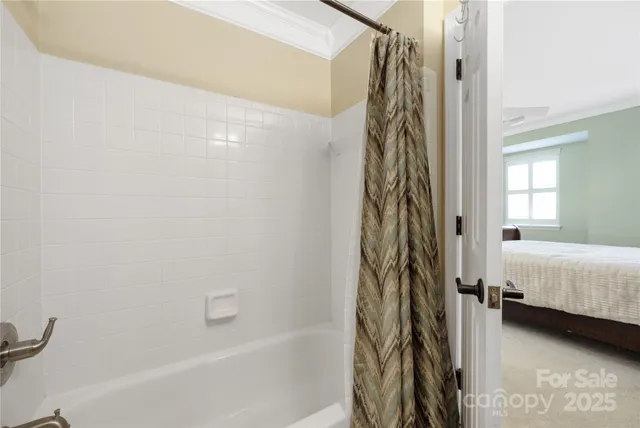 a bathroom with a shower curtain and a window