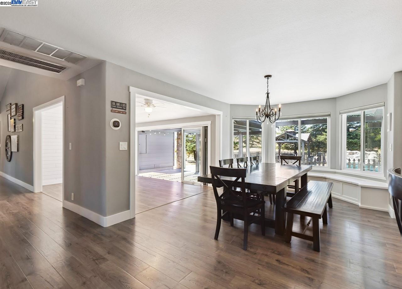 8191 Highland Road Livermore, CA 94551 - Photo 12 of 59 a view of a dining room with furniture window and wooden floor
