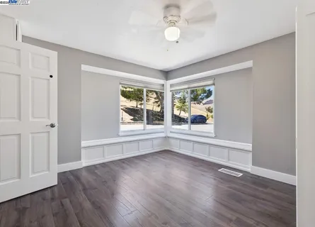 a bathroom with double vanity and a mirror