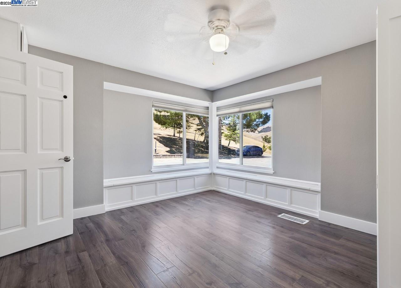 8191 Highland Road Livermore, CA 94551 - Photo 23 of 59 an empty room with wooden floor and windows