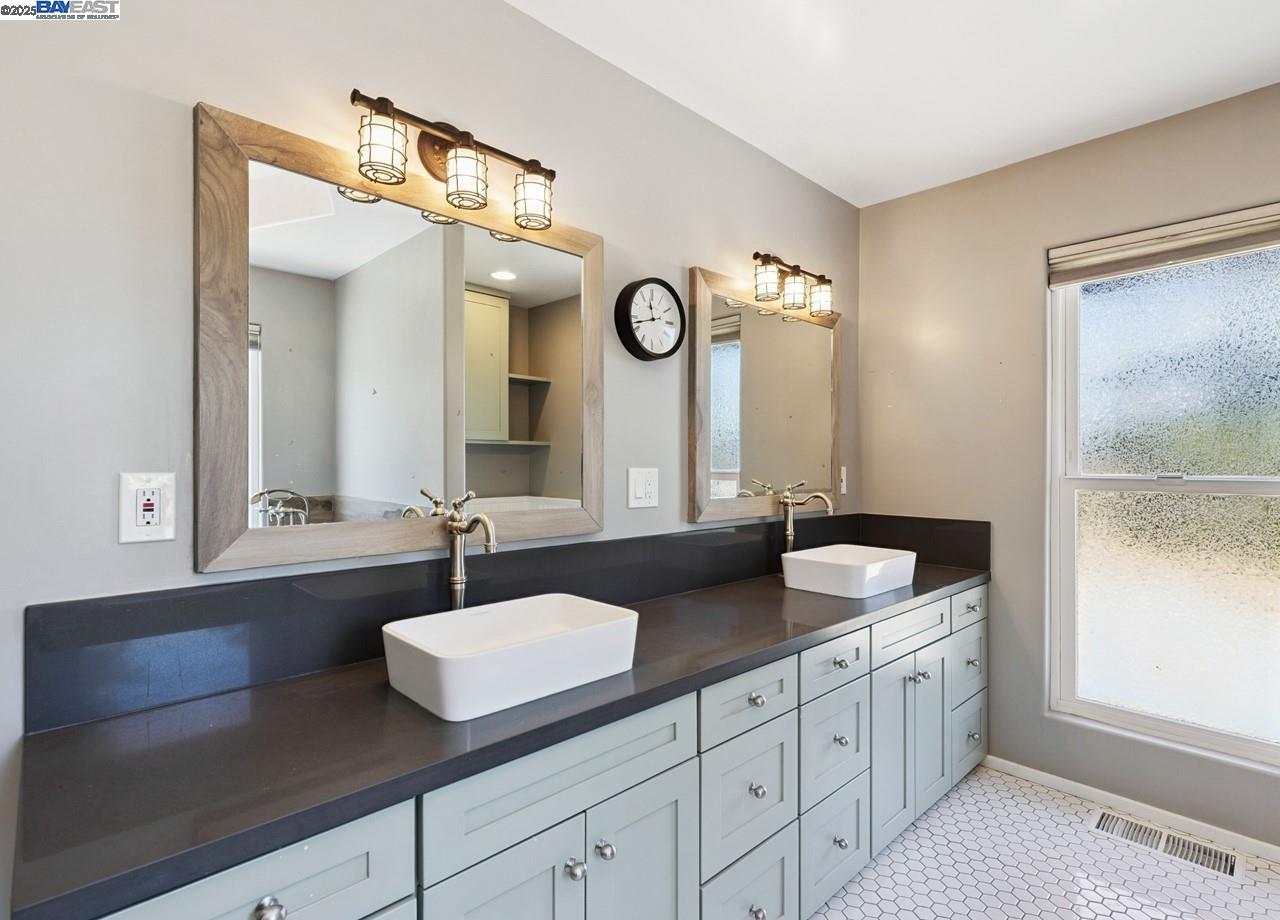 8191 Highland Road Livermore, CA 94551 - Photo 26 of 59 a bathroom with double vanity and a mirror