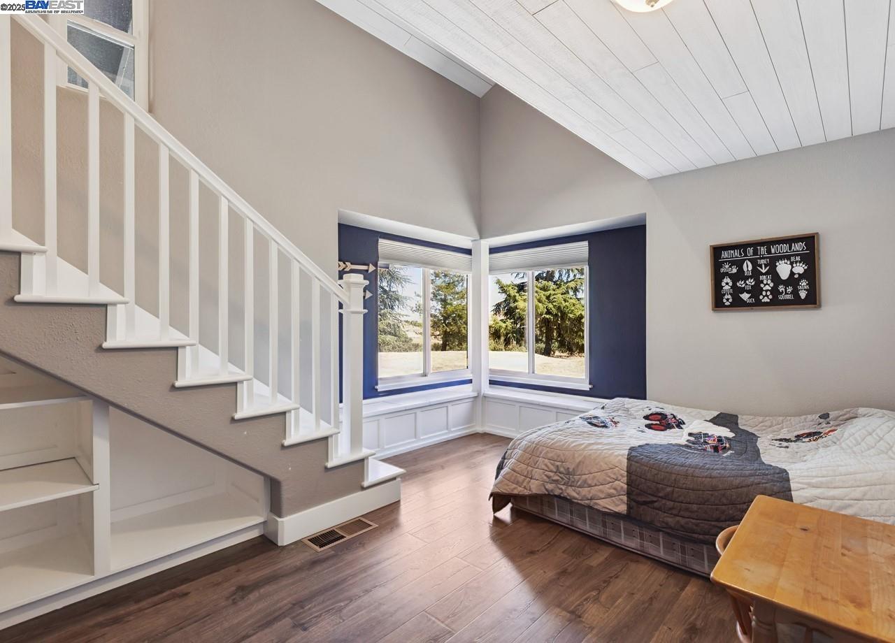 8191 Highland Road Livermore, CA 94551 - Photo 28 of 59 a spacious bedroom with a bed and a window with wooden floor