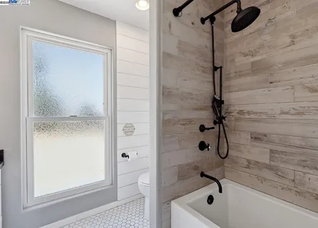 a view of a swimming pool with a patio and a yard