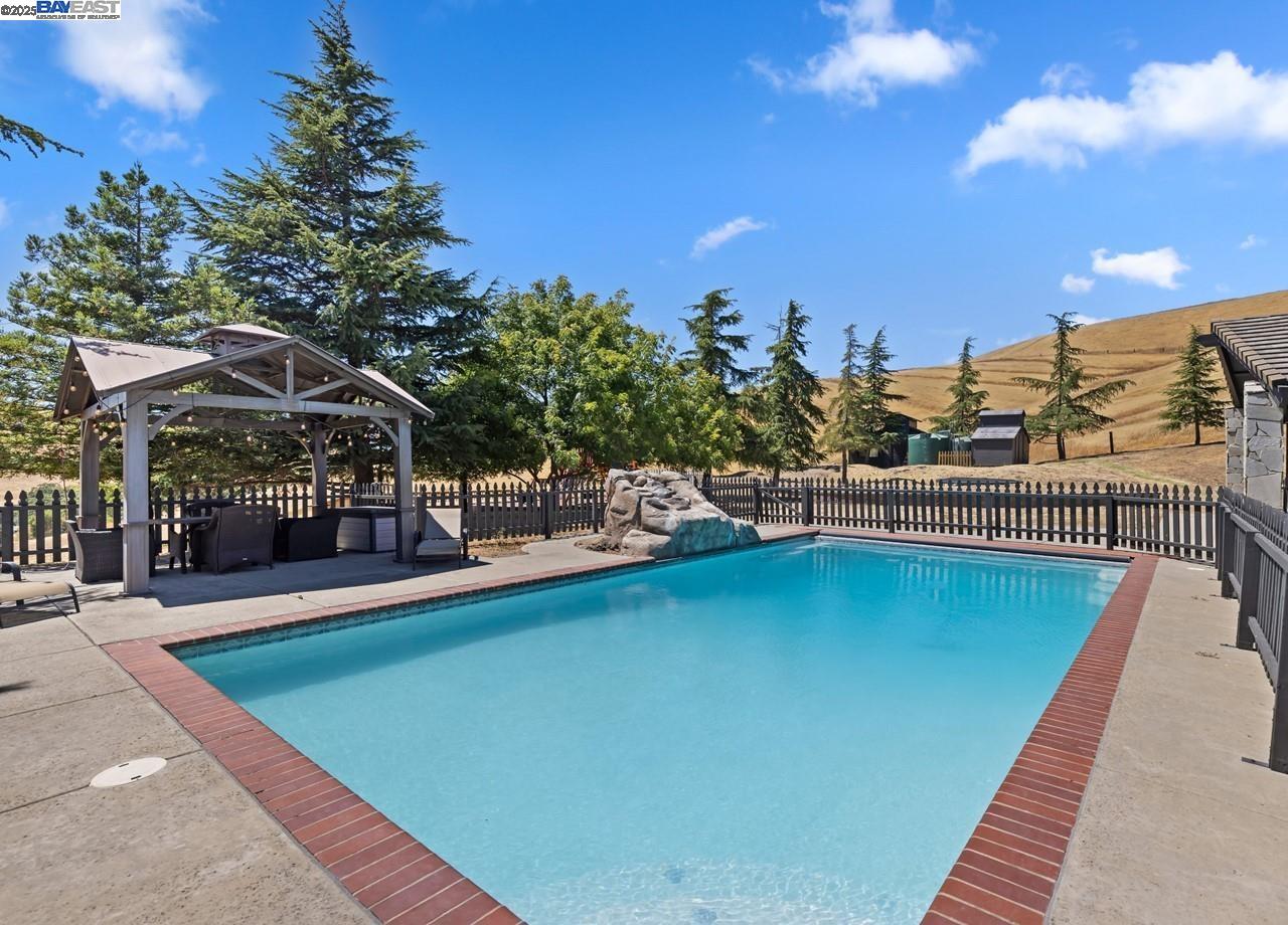 8191 Highland Road Livermore, CA 94551 - Photo 35 of 59 a view of a swimming pool with a patio and a yard