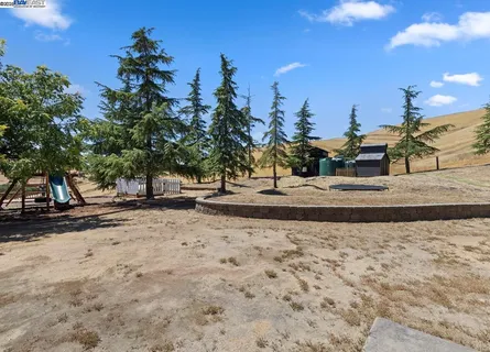 a swimming pool with trees in the background